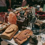 A table full of various items at a flea market