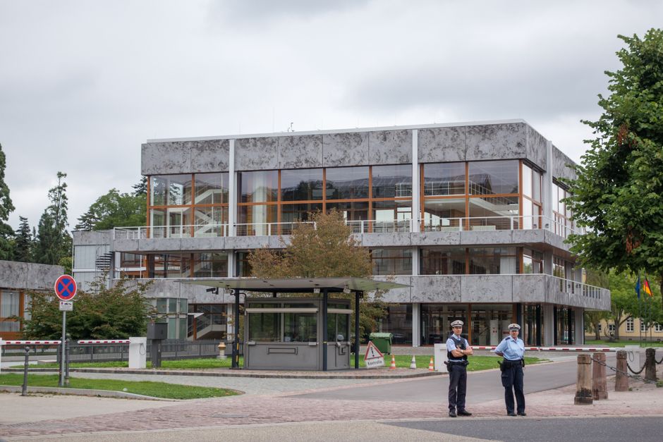 Modern building exterior in Karlsruhe, Germany, with security presence.