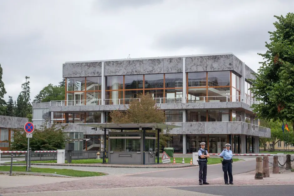 Modern building exterior in Karlsruhe, Germany, with security presence.